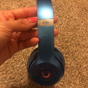 Light Blue Beats solo headphones